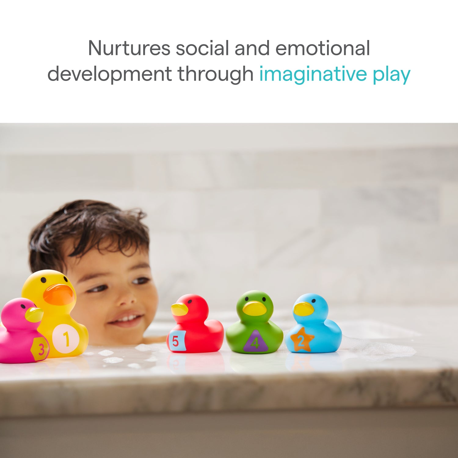 A young child smiles in the tub, playing with Munchkin US UAT Count Quack Bath Duckies—each a different color and numbered. Text reads, “Nurtures social and emotional development through imaginative play.”.